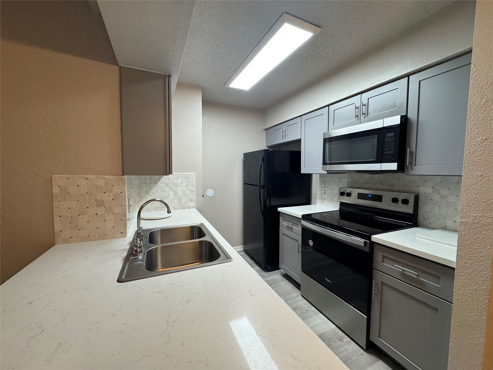 10101 South Gessner Road, Unit 305 Houston, TX 77071 - Photo 7 of 18 a kitchen with a sink and steel appliances