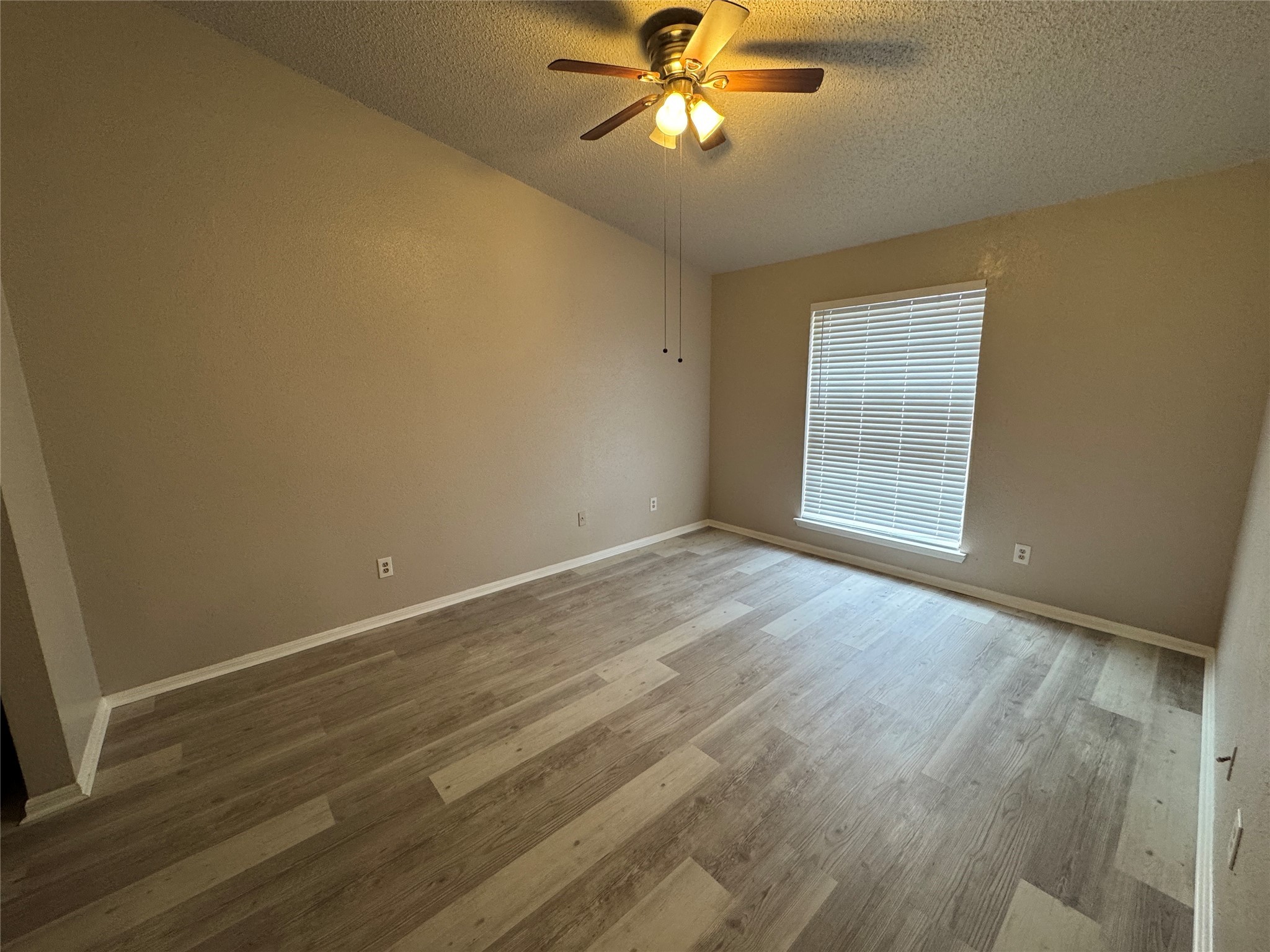 10101 South Gessner Road, Unit 305 Houston, TX 77071 - Photo 9 of 18 wooden floor in an empty room with a window