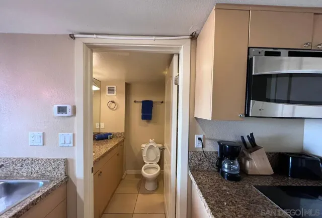 a bathroom with a granite countertop sink a vanity and a mirror