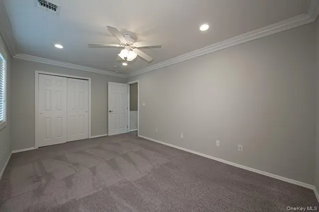 an empty room with a fan and a fan