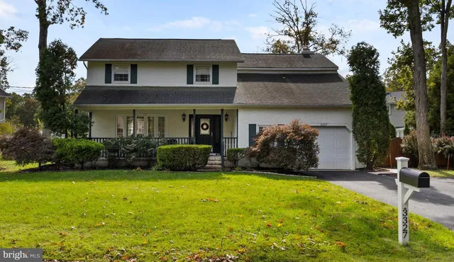 a view of a house with patio next to a yard
