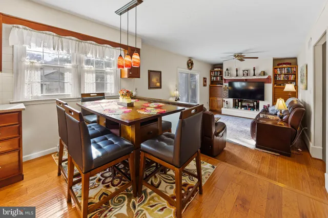 a dining room with furniture and wooden floor