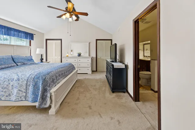 a bed room with a bed and a chandelier