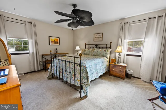 a bedroom with a bed a table and chair