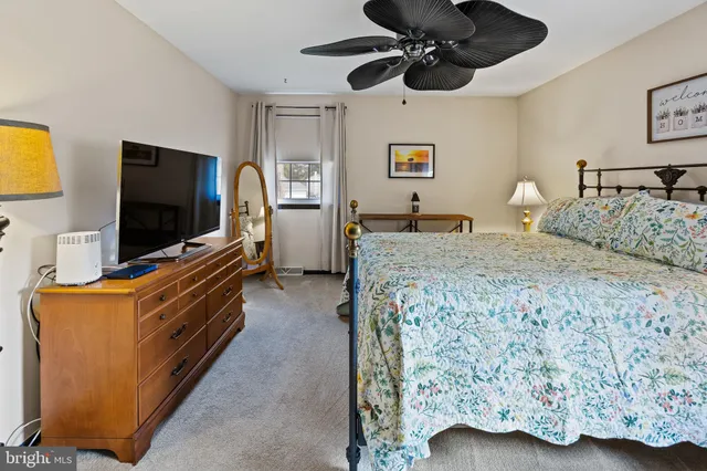 a bedroom with a bed and a desk