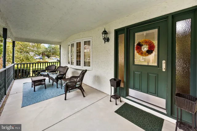 a view of a house with a yard and sitting area