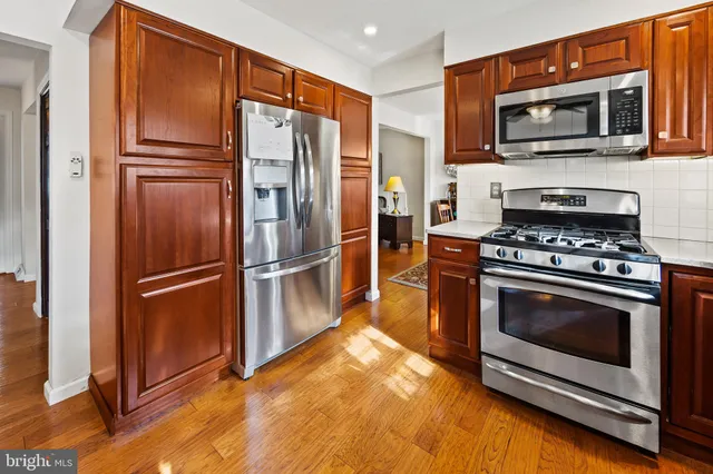 a kitchen with stainless steel appliances granite countertop a refrigerator microwave and stove top oven