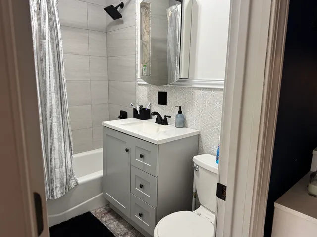 a bathroom with a sink toilet and tub