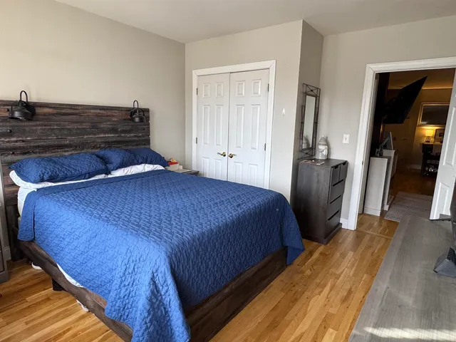 a bedroom with a bed and a mirror
