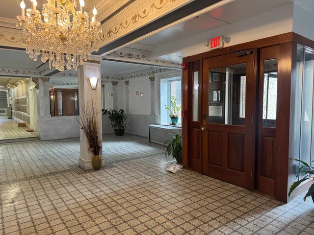 a kitchen with stainless steel appliances kitchen island granite countertop a stove and a refrigerator