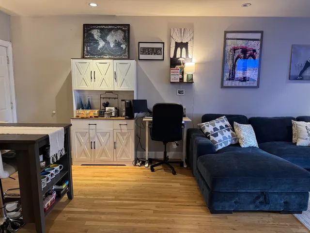 a living room with furniture and painting on the wall