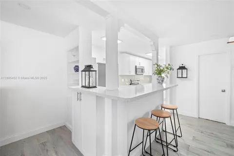 a kitchen with a table and chairs in it