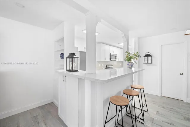 a kitchen with a table and chairs in it