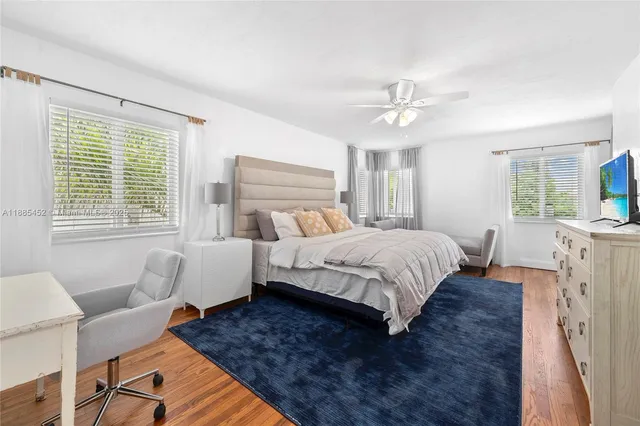 a bedroom with a bed couch and a window