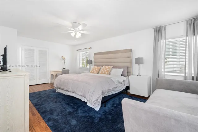 a spacious bedroom with a bed and a chandelier