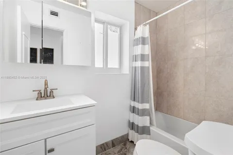 a bathroom with a sink toilet a mirror and shower