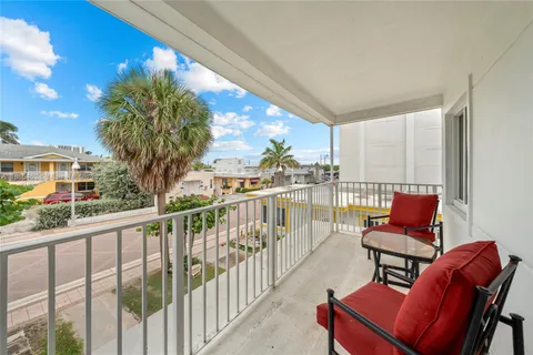 a view of a chair and tables in the balcony