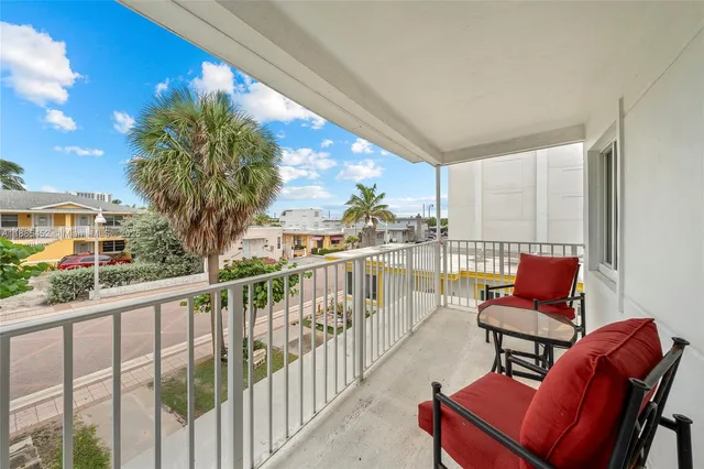 a view of a chair and tables in the balcony