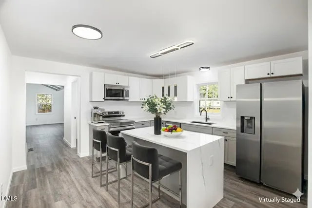 an empty room with wooden floor and door