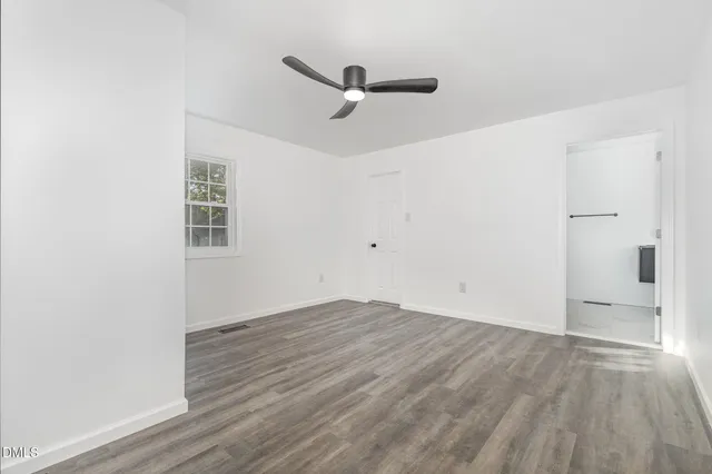 a bedroom with a bed and a chair