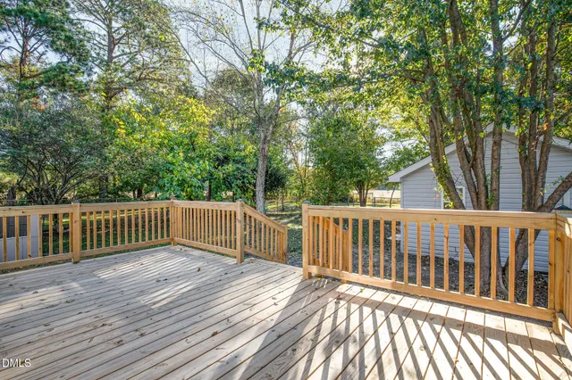 a bathroom with a bathtub shower sink mirror vanity and toilet