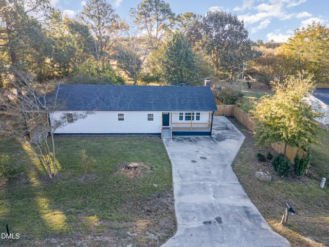 a aerial view of a house with a yard