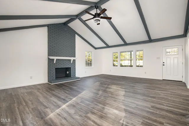 a view of a porch with wooden floor and roof