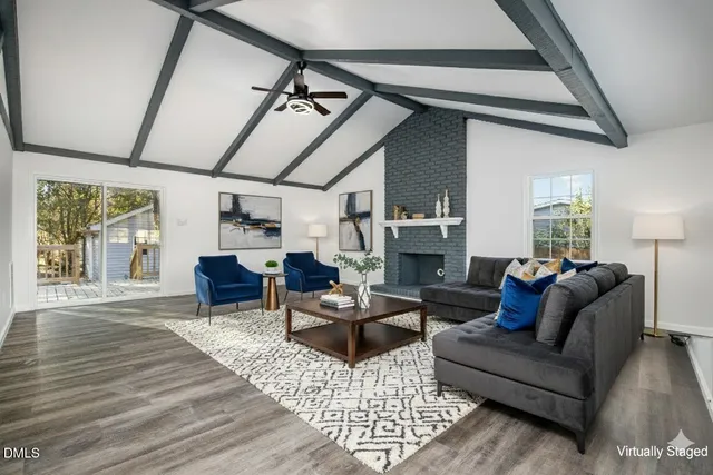 a view of an empty room with a fireplace and a window