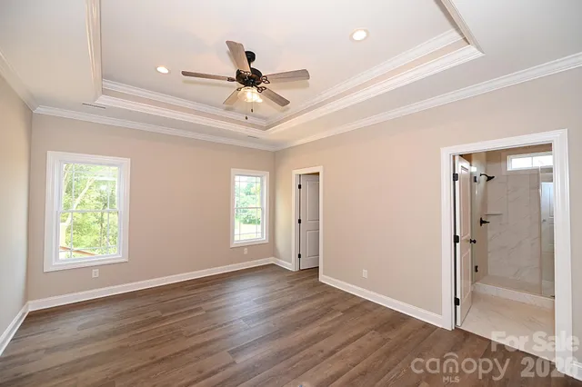 a bathroom with a granite countertop sink a toilet and shower
