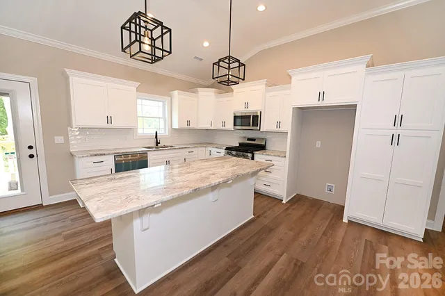 a large kitchen with cabinets and stainless steel appliances
