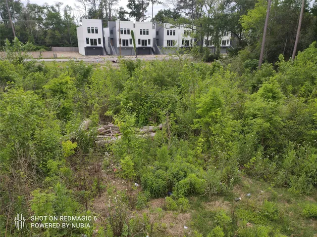 a view of a house with a yard balcony and sitting area