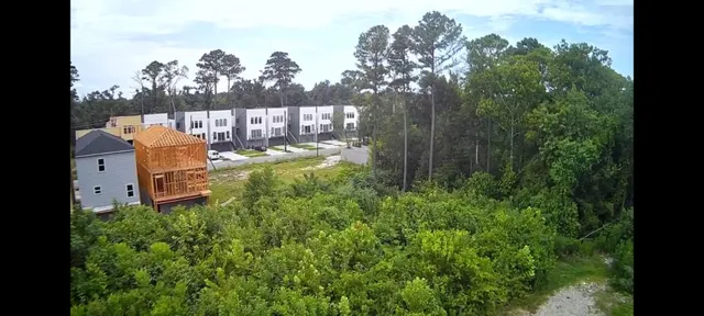 a view of a swimming pool with a patio and a yard