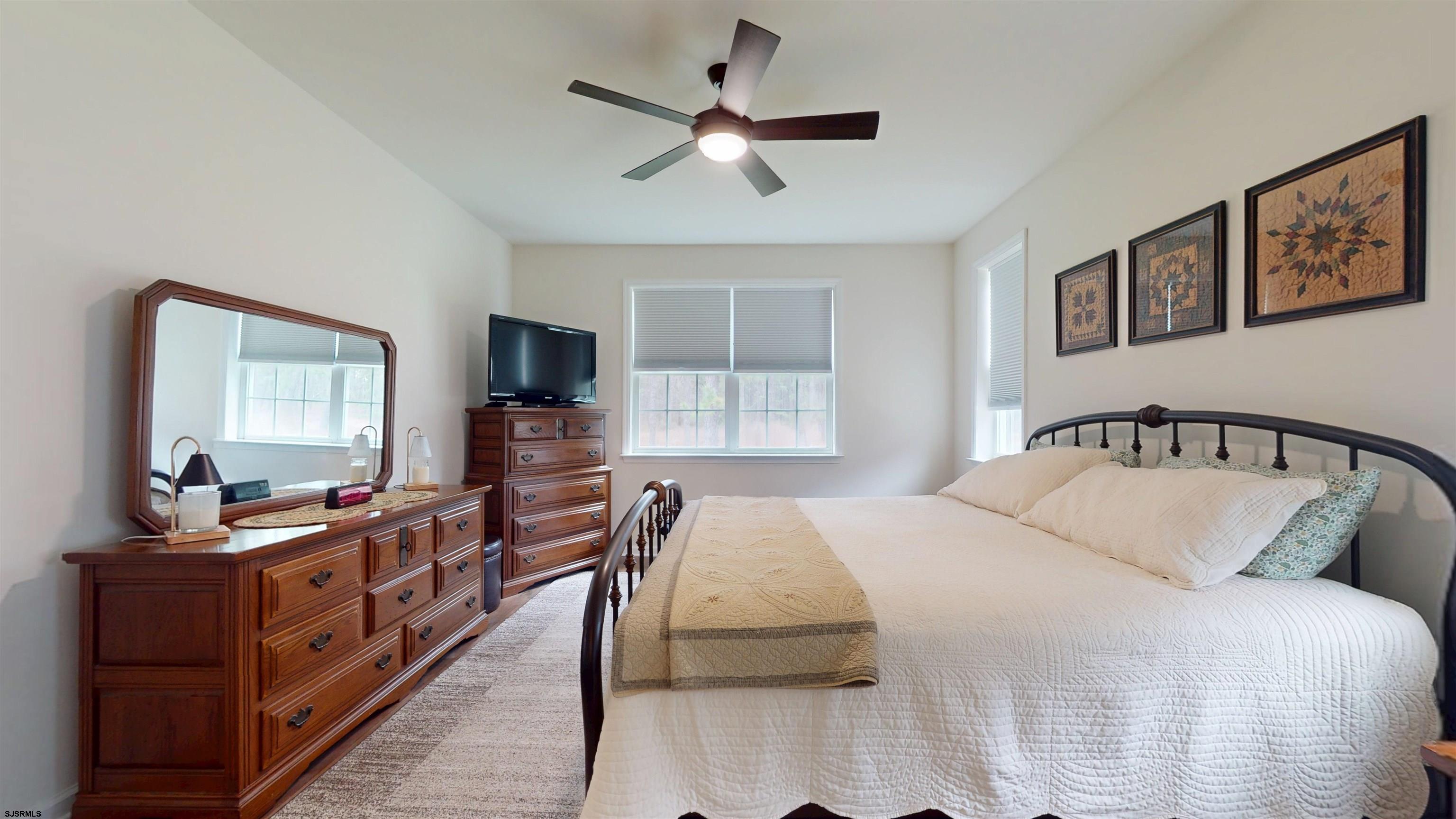 185 Keller Way Mays Landing, NJ 08330 - Photo 26 of 56 a bedroom with a large bed and a flat tv screen on a dresser