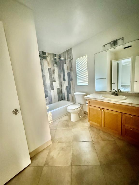 970 Amy Ridge Court Kissimmee, FL 34747 - Photo 11 of 18 a bathroom with a sink a toilet and shower