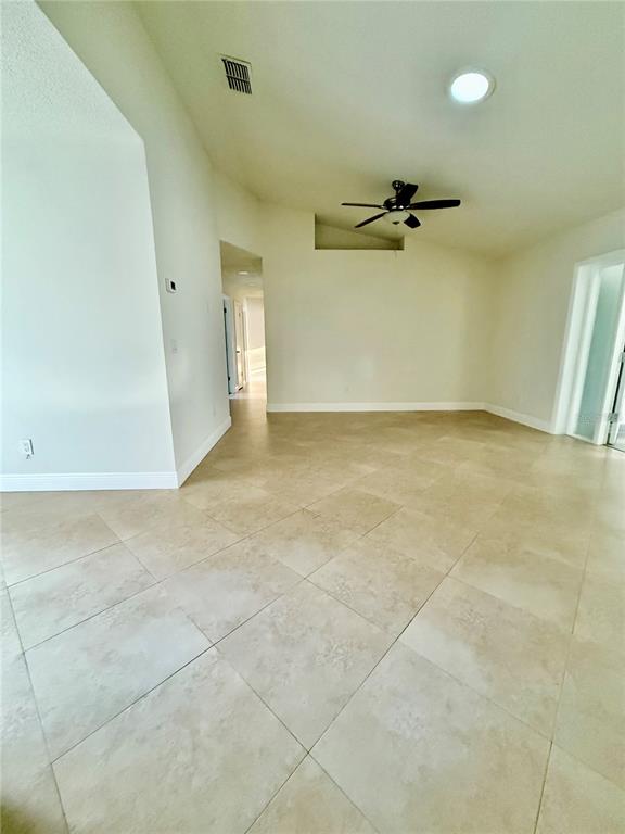 970 Amy Ridge Court Kissimmee, FL 34747 - Photo 13 of 18 an empty room with a ceiling fan and window