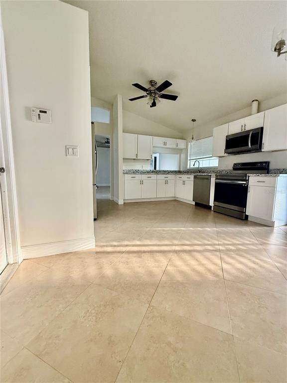 970 Amy Ridge Court Kissimmee, FL 34747 - Photo 15 of 18 a view of a kitchen with a sink and a refrigerator
