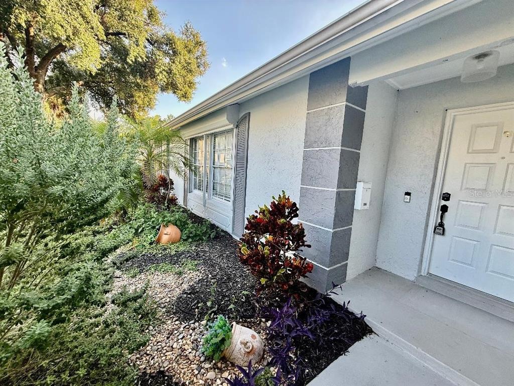970 Amy Ridge Court Kissimmee, FL 34747 - Photo 3 of 18 a view of a house with a yard and potted plants