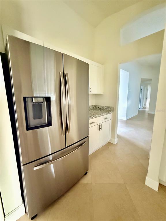 970 Amy Ridge Court Kissimmee, FL 34747 - Photo 8 of 18 a kitchen with stainless steel appliances a refrigerator sink and microwave