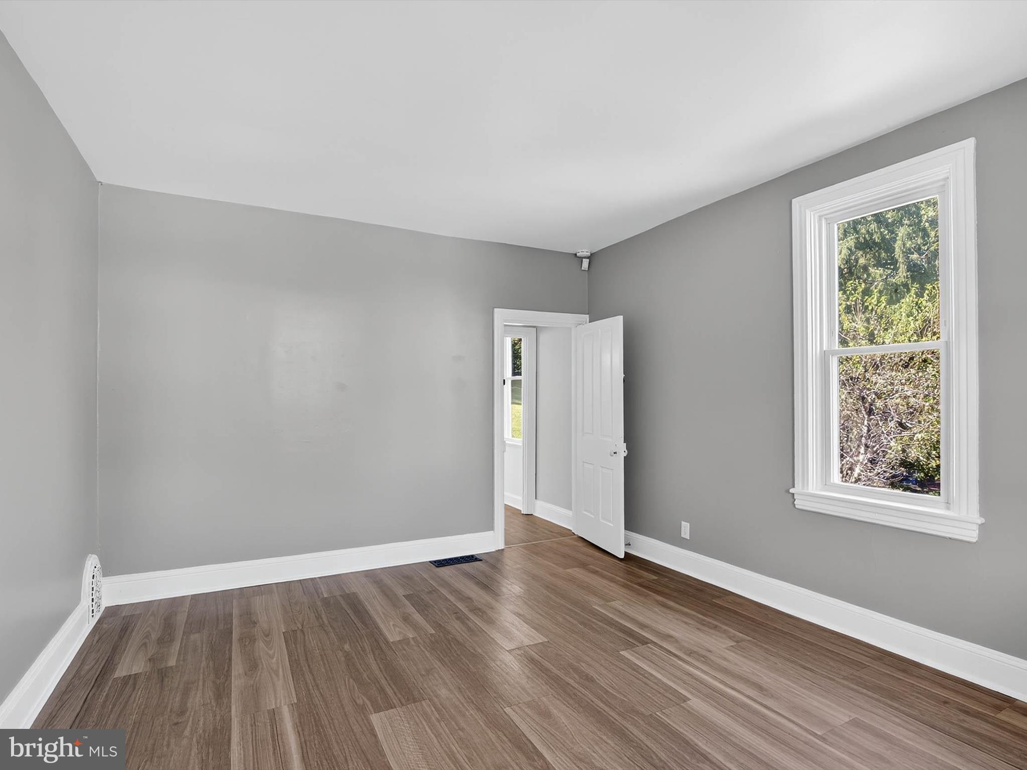 5334 Strasburg Road Kinzers, PA 17535 - Photo 21 of 44 a view of an empty room with wooden floor and a window