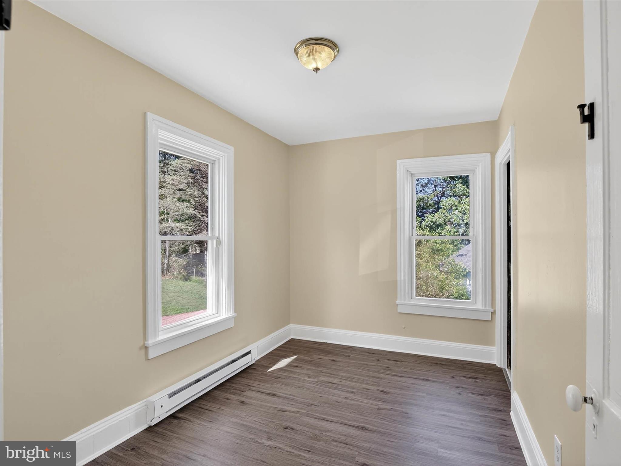 5334 Strasburg Road Kinzers, PA 17535 - Photo 23 of 44 a view of an empty room with wooden floor and a window