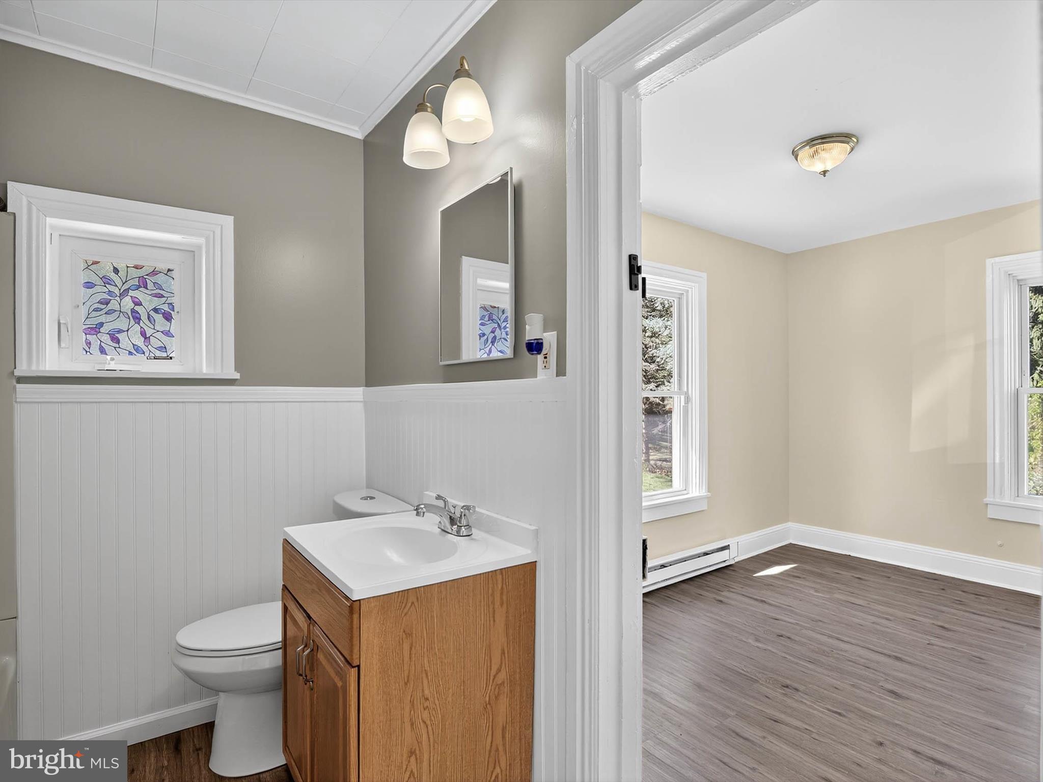 5334 Strasburg Road Kinzers, PA 17535 - Photo 25 of 44 a bathroom with a sink mirror vanity and toilet