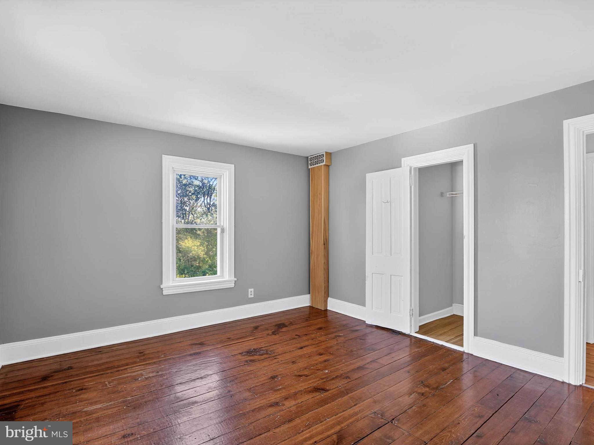 5334 Strasburg Road Kinzers, PA 17535 - Photo 26 of 44 a view of an empty room with wooden floor and a window
