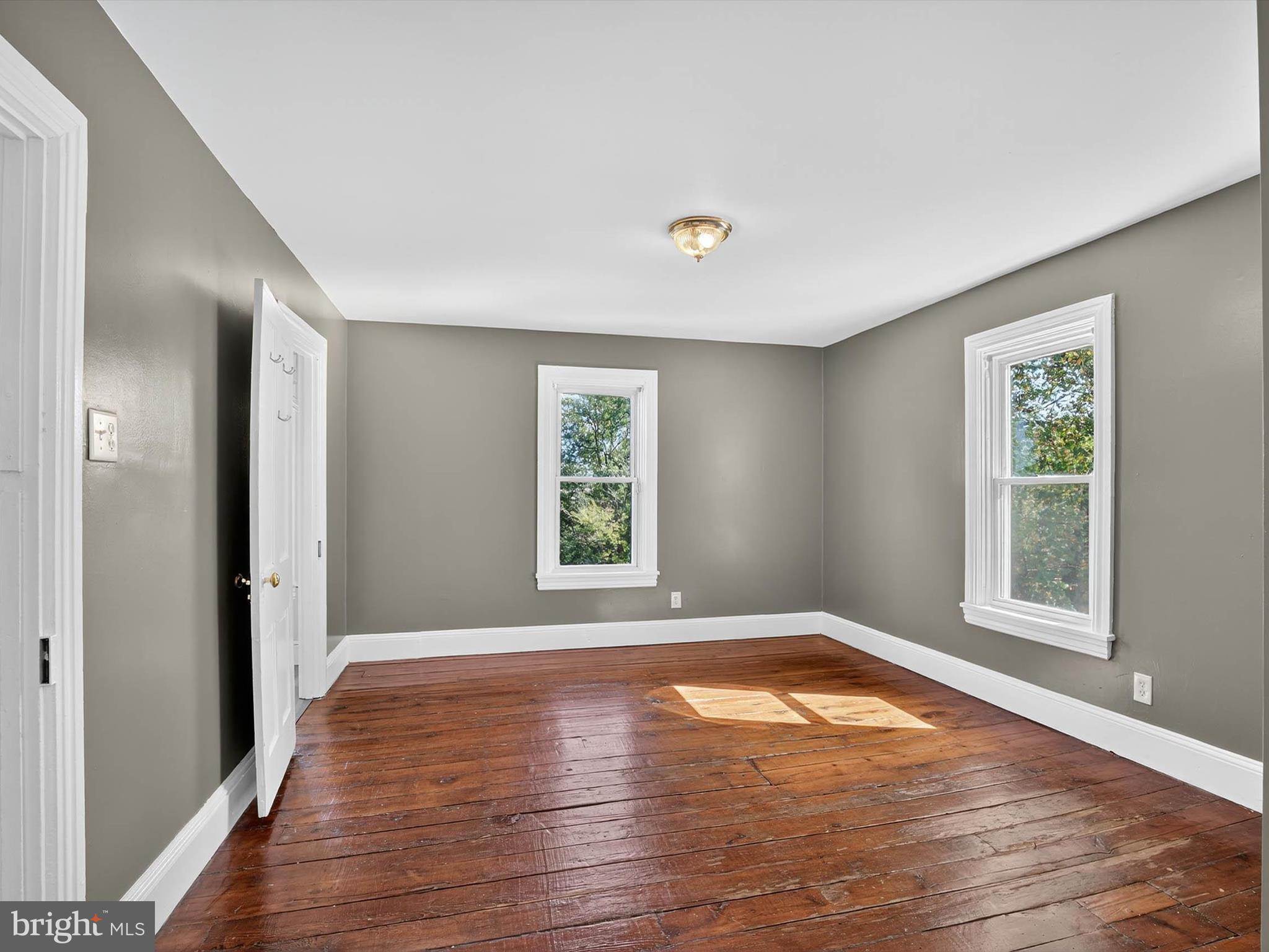 5334 Strasburg Road Kinzers, PA 17535 - Photo 29 of 44 an empty room with wooden floor and windows