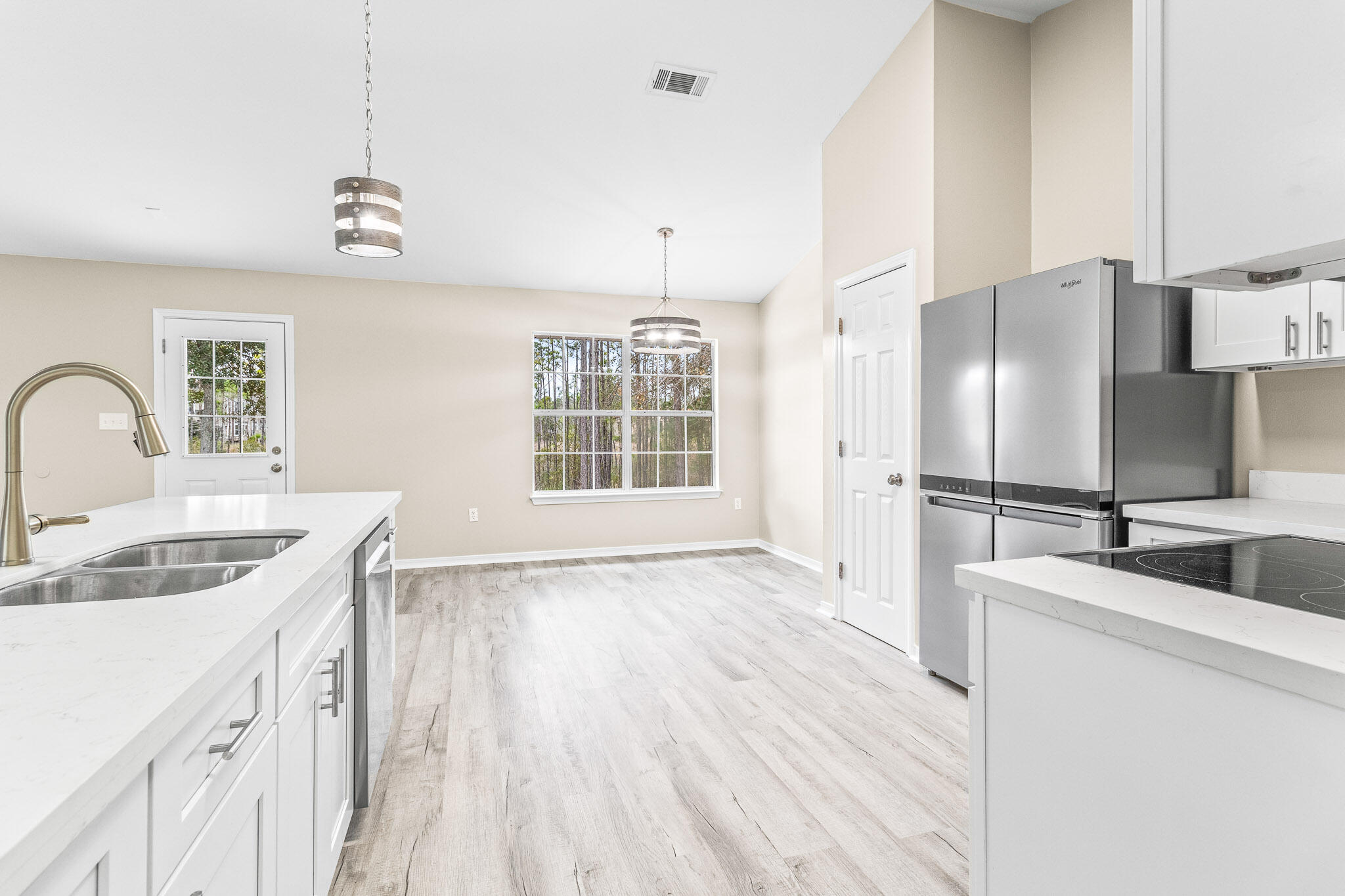 230 Beacon Way Santa Rosa Beach, FL 32459 - Photo 25 of 46 a kitchen with stainless steel appliances granite countertop a sink dishwasher and a refrigerator with wooden floor