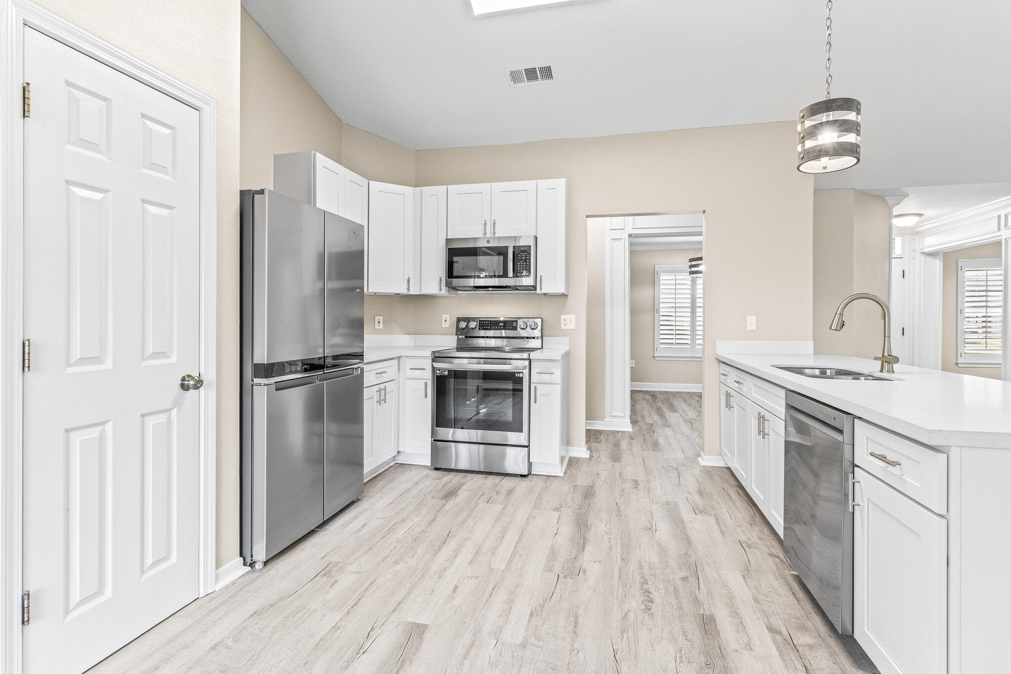 230 Beacon Way Santa Rosa Beach, FL 32459 - Photo 26 of 46 a large kitchen with a center island wooden floor stainless steel appliances and cabinets