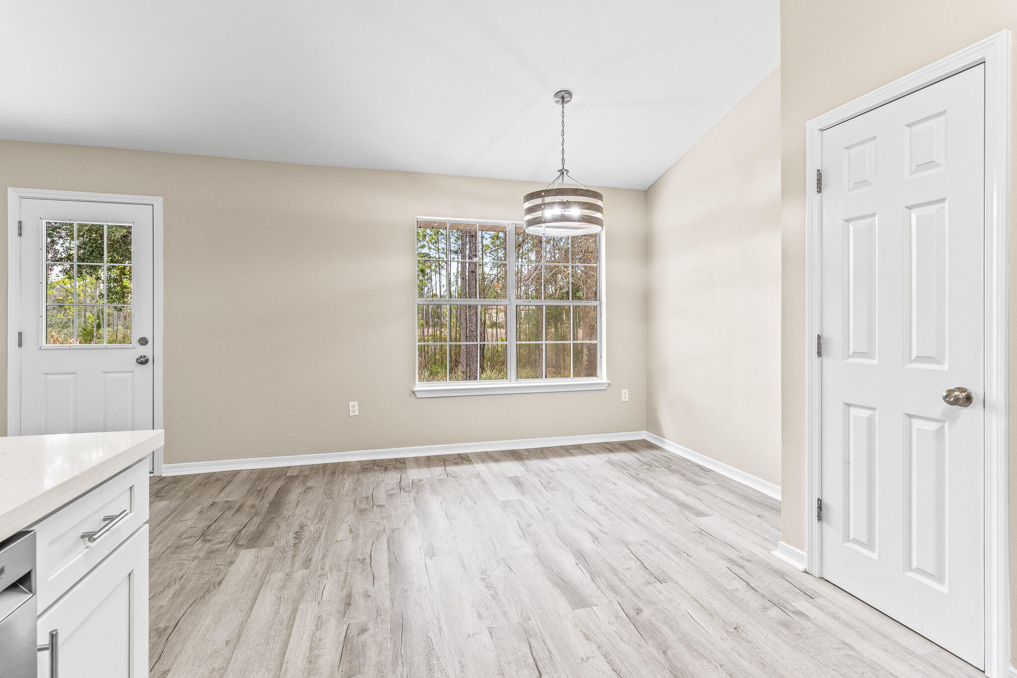230 Beacon Way Santa Rosa Beach, FL 32459 - Photo 29 of 46 a view of an empty room with wooden floor and a window