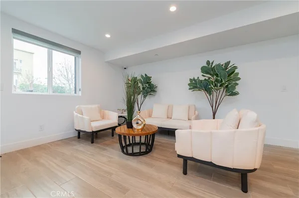 a living room with furniture and a potted plant