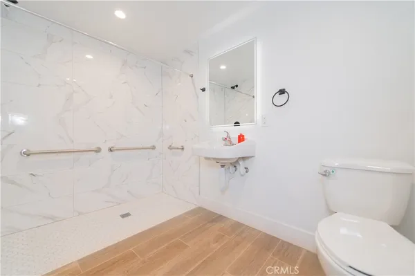 a bathroom with a toilet and a shower