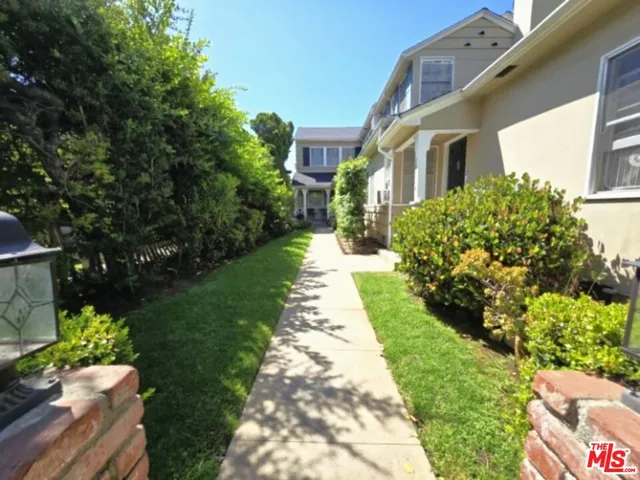 a view of a pathway with a house in the background