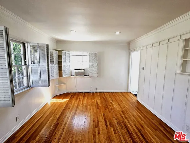 a view of room with wooden floor and window